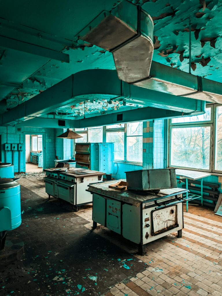 An abandoned room full of old junk appliances